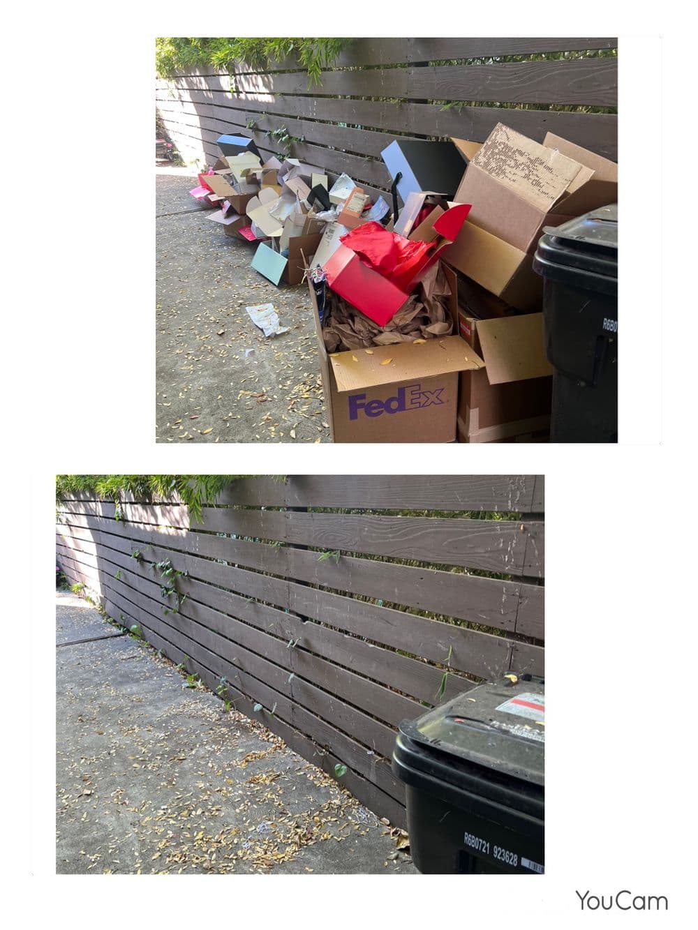 Overflowing cardboard boxes and trash bins next to a wooden fence in a narrow alleyway.